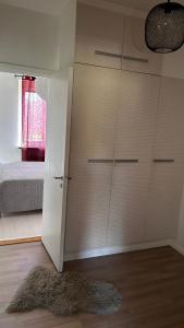 a bedroom with a closet and a bed and a rug at Centrumnära in Gothenburg
