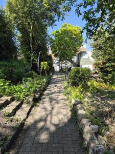 a brick path with trees and a house in the background at Castle View Hotel in Chepstow