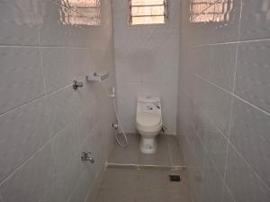 a bathroom with a white toilet in a stall at Olulu Place in Frere Town