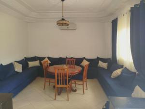 a dining room with a table and chairs at Apartment with pool next to the ocean in Agadir nʼ Aït Sa