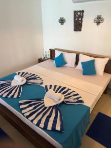 two beds in a room with towels on them at Check Point in Unawatuna +16 photos