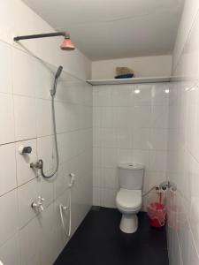 a bathroom with a toilet and a shower at Check Point in Unawatuna