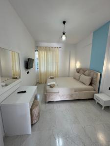 a living room with a bed and a couch at Hotel Irini in Sarandë