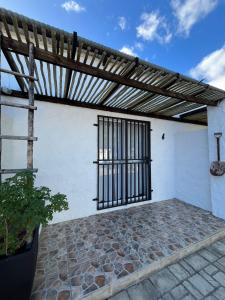 a patio with a metal gate on the side of a building at Windpomp Guesthouse in Beaufort West