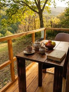 a wooden table with a bowl of fruit on a deck at Camping Three poplars by VL in Alaverdi