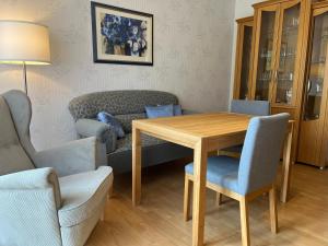a living room with a table and chairs and a couch at Ferienwohnung "Am Wichtelweg", 95176 in Rhauderfehn