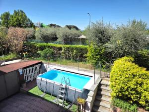 a small swimming pool in a yard with stairs and trees at Casa PO LAZISE in Lazise