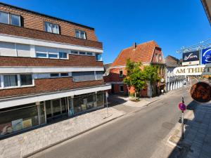 an empty street in a town with a building at FeWo- Room Rental Rheine in Rheine