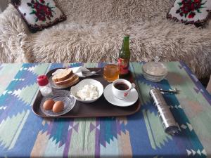 a tray with eggs and bread and coffee on a table at Apartman Sadba 2 in Goražde