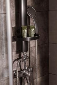 a mirror and two cups on a stand in a shower at Ederlezi Boutique Hotel in Athens +90 photos