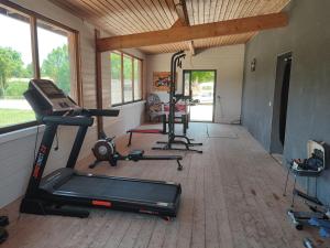 a gym with two exercise bikes and a treadmill at Tiny House nature & détente, Vercors, terrasse, vue montagne in La Motte-Fanjas