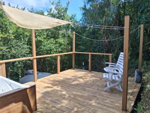 a deck with two chairs and an umbrella at Neptunes Home in Saint John