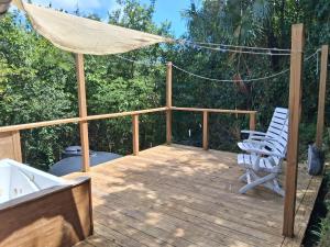 a deck with two chairs and an umbrella at Neptunes Home in Saint John