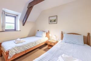 two twin beds in a room with a window at 4 Bed in Westward Ho oc-n1623 in Westward Ho