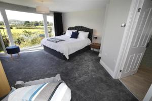 a bedroom with a bed and a large window at 4 Bed in Swansea oc-hh682 in Parkmill