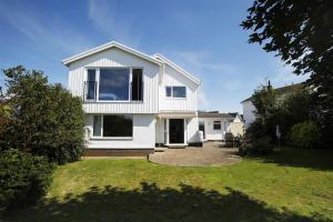 a white house with a large window on a yard at 4 Bed in Swansea oc-hh682 in Parkmill