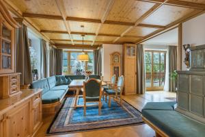 a living room with a table and chairs at Villa Schwarzbrunn in Stans