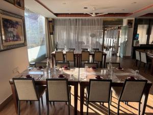 a dining room with a large table and chairs at Hotel Ugyen, Thimphu in Thimphu