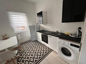 a kitchen with a washing machine and a sink at Ferienwohnung Monteurwohnung in Wadern