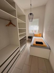 a bedroom with a bed and a closet at Ferienwohnung Monteurwohnung in Wadern