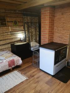 a room with a refrigerator and a bed in it at Köleri B&B in Suure-Jaani +6 photos