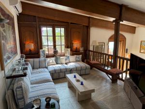a living room with a couch and a table at Villa Mitzela in Amaliapoli