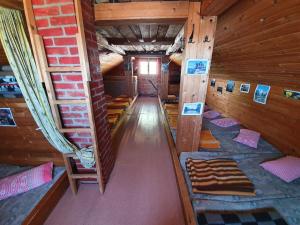 a room with several bunk beds in a cabin at Zavetišče pod Špičko in Soča