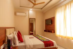 a bedroom with a bed and a ceiling fan at Aureva Kamla Heritage in Jaipur