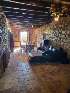 a living room with a couch and a table at Can Cuti in Santa Eulalia de Ríuprimer