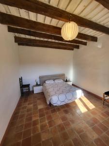 a bedroom with a bed in a room with a ceiling at Can Cuti in Santa Eulalia de Ríuprimer