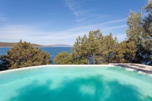 a swimming pool with a view of the water at Villa Mitzela in Amaliapoli