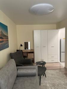 a living room with a couch and a refrigerator at Comfort Haven Apartments in Jõhvi