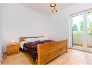 a bedroom with a bed and a large window at Villa Dalmacija in Drniš