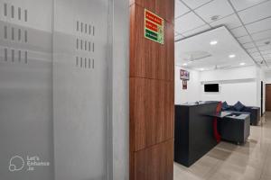 an office with a wooden partition and a desk at Hotel Wow in Surat