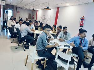 a group of people sitting at tables in a room at Hotel Wow in Surat +10 photos
