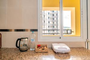 a kitchen with a counter top with a window at First Line Beach & Free Parking in Tangier +13 photos