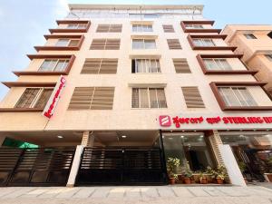 a building with a sign in front of it at ECKO Sterling Inn Near Bangalore International Airport in Bangalore