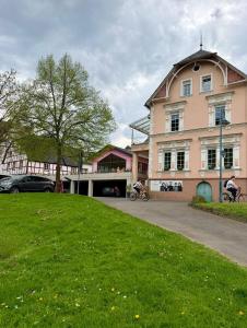 a large building with people riding bikes in front of it at Moselena in Reil