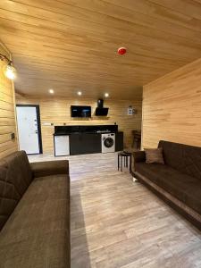 a living room with a couch and a kitchen at Nirvana Suite Hotel in Uzungöl