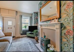 a living room with a fireplace and a tv at Ivydene Cottage Hawsker in Whitby