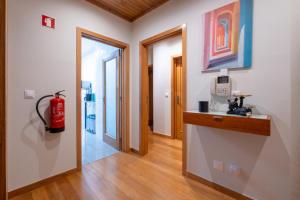 a hallway with a fire hydrant in a room at FamilyHub - EcoHost - Spacious 3-bedroom apartment for 8 people with AC and parking near Porto and the beaches in Senhora da Hora