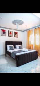 a bedroom with a large bed with a large couch at Malindi Leisure homes in Malindi