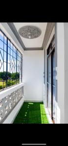 a room with a balcony with green grass and windows at Malindi Leisure homes in Malindi