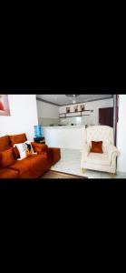 a living room with two couches and a white chair at Malindi Leisure homes in Malindi