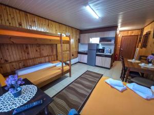 a room with two bunk beds and a kitchen at Ваканционно селище Ива in Sarnitsa