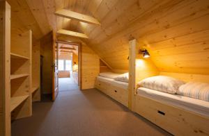 a room with two beds in a wooden cabin at Chata a Chalety Starý mlyn in Veľká Franková