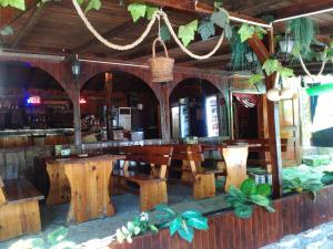 a restaurant with wooden tables and a bar at Nimpha Bungalows in Kamchia