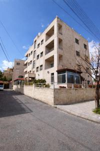 an apartment building on the side of a street at Spacious Apartment in Amman
