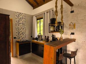 a kitchen with a wooden counter top in a room at Vale Infinito Chalé in Córrego do Bom Jesus