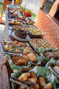 a buffet line with many different types of food at Prime Garden Pousada in Socorro